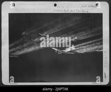 Vapor trails over Munich--Boeing B-17 Flying Fortresses of the 15th Air Force, flying high above Germany, make vapor trails in the enemy's sky. 20th bomb Sqdrn. 2nd Bomb Group. Stock Photo