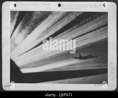 Vapor trails from a Boeing B-17 Flying Fortress on way to bomb targets in Germany. These 'Flying Fortresses' are with the 8th Air Force in England. Stock Photo