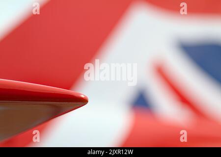 Wing Tip Of A Royal Air Force Red Arrow Hawk T1 Acrobatic Display Jet Against The Red White And Blue Union Jack Of The Tail, Bournemouth UK Stock Photo