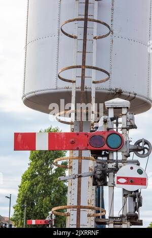 old steam railway water tank and semaphore signal arm at the preservation railway in swanage dorset uk, preserved railway equipment and railwayana. Stock Photo