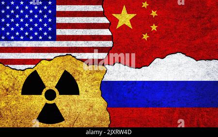 Flags of USA, Russia, China and radiation symbol on a wall. United States of America, China and Russia Nuclear Deal or Tensions concept Stock Photo