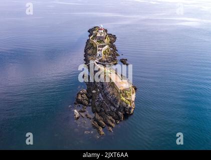 Aerial of the Rotten Island Lighthouse with Killybegs in background - County Donegal - Ireland. Stock Photo