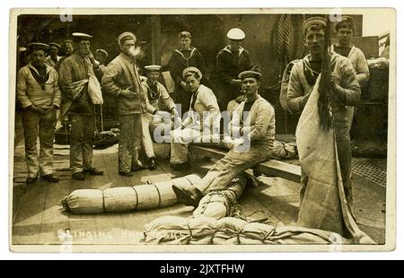 Original WW1 era postcard of group of Royal navy sailors slinging hammocks on a ship, lots of characters, one man is smoking,  dated and posted from Portsmouth on October 5th 1916, just before the end of the war, U.K. Stock Photo