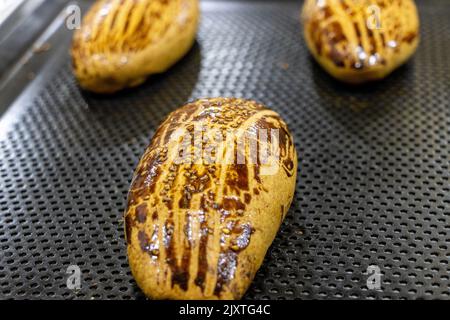 Hot and fresh pastry in a tray. Turkish name: Pogaca Stock Photo