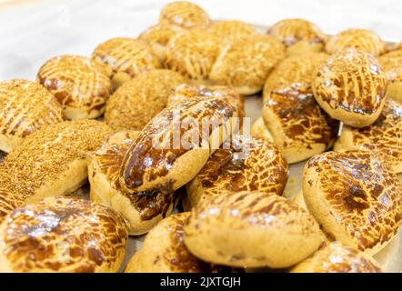 Hot and fresh pastry in a tray. Turkish name: Pogaca Stock Photo