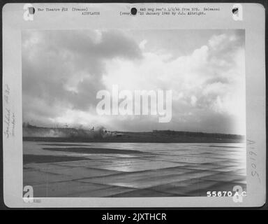 A 9th Air force Lockheed P-38 Lightning fighter-bomber, one of its propellers still turning (left of the tail) despite detachment from an engine, crash lands at its base near the battle zone. Attacking targets holding up the advance of U.S. infantry Stock Photo