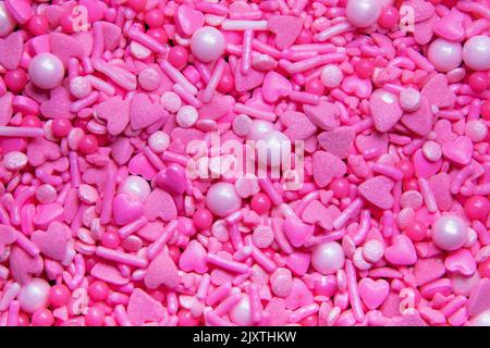 Full frame shot of pink sprinkles and hearts Stock Photo