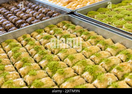 Turkish and Middle Eastern dessert, Local name: Baklava.  Pistachio dough desserts in the tray Stock Photo