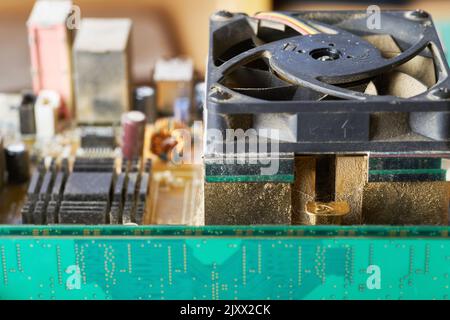 Old motherboard covered in dust and dirt. Close-up. Stock Photo