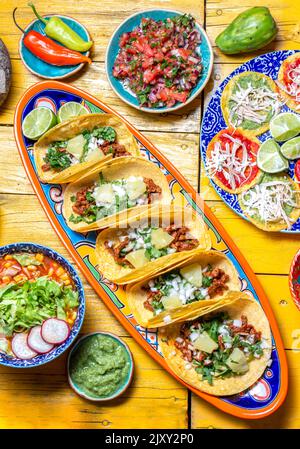 Mexican festive food for independence day - independencia chiles en nogada, tacos al pastor, chalupas pozole, tamales, chicken with mole poblano sauce Stock Photo