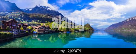 Stunning idylic nature scenery of mountain lake Brienz. Switzerland, Bern canton. Iseltwald village surrounded turquoise waters Stock Photo