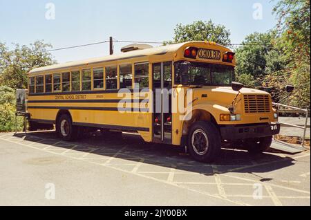 Yellow American school bus converted into a rum distillery, Dartington Cider Press, Devon, England, United Kingdom. Stock Photo