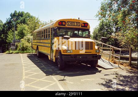 Yellow American school bus converted into a rum distillery, Dartington Cider Press, Devon, England, United Kingdom. Stock Photo