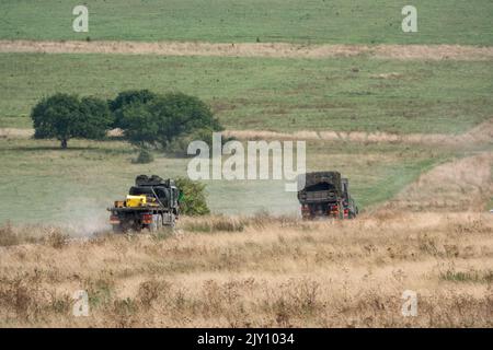 British army MAN HX58 6x6 Heavy Utility Truck EPLS in action on a military exercise Stock Photo