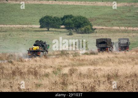 British army MAN HX58 6x6 Heavy Utility Truck EPLS in action on a military exercise Stock Photo