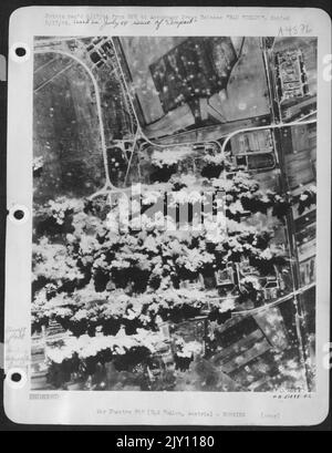 Consolidated B-24 Liberator bombers of the U.S. 15th AF makes finest example precision bombing attack on the Bad Voslau Aircraft plant in Austria. (After attack). Stock Photo
