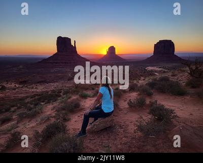 Woman watching beautiful sunrise scenery at Monument Valley, Utah Stock Photo
