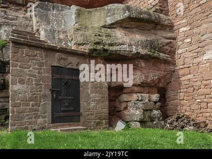 A unique wooden doorway in a castle made out of sandstone blocks Stock Photo