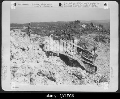 A Bulldozer, Operated By Men Of The 1878Th Engineer Aviation Battalion, Climbs A Steep Grade At The Stone Quarry On Okinawa, Ryukyu Retto. 1945. Stock Photo