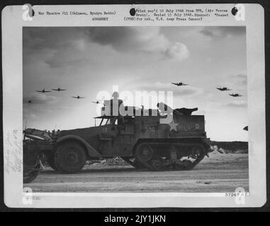 Returning From A Strike On The Japanese Mainland Republic P-47 Thunderbolts Of The 318Th Fighter Group In The Okinawa Islands Buzz Their Home Field, Passing Low Over An Anti-Paratroop Halftrack. Stock Photo