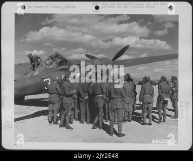 Chinese Aircraft Spotters Are Trained To Recognize American Aircraft. Here, They Study The Features Of A Lockheed P-38 'Lightning' At A 14Th Air Force Base In China. Stock Photo