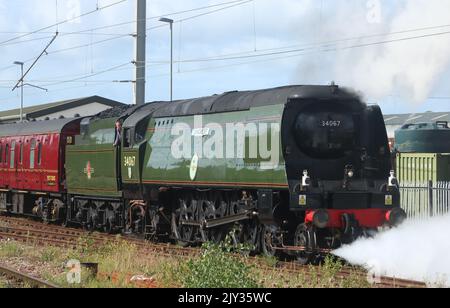 Battle of Britain class steam engine 34067 Tangmere with support coach backing on to the Northern Belle luxury train at Carnforth 7th September 2022. Stock Photo
