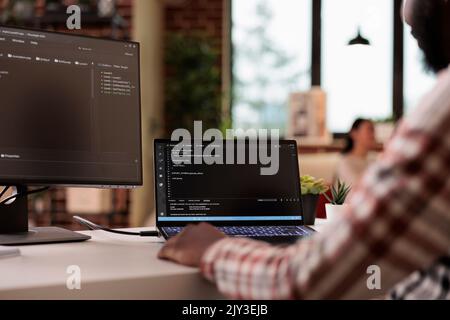 Software developer programming firewall security on multiple monitors, learning new user interface. Developing application cloud server with binary code and html script on terminal window. Stock Photo