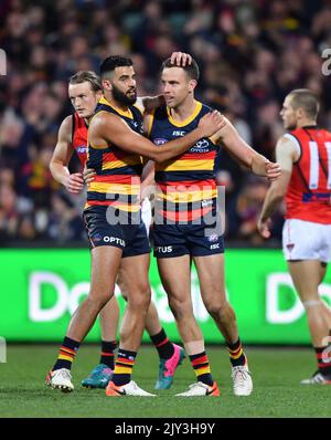 Brodie Smith of the Crows celebrates his goal with Taylor Walker