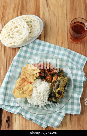 Warung Tegal Menu, Rice with Various Side Dish Popular in Indonesia with Cheap Price. Top View on Wooden Table Stock Photo