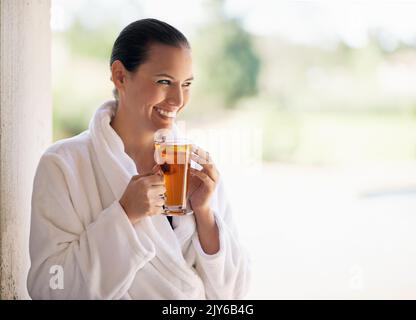 The spa is her sanctuary. a young woman drinking an iced tea at the day spa. Stock Photo