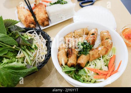 Bún Chả with spring rolls and Chả tôm (sugarcane prawns) with rice paper at Phu Quoc, a Vietnamese restaurant in Cabramatta — Sydney, Australia Stock Photo