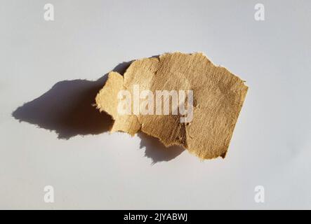 Recycled paper craft stick on a white background. Brown paper torn or ripped pieces of paper isolated on white with clipping path. Stock Photo