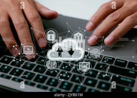 A cloud computing diagram is displayed on a laptop in the hands of a man. Networking and internet service principles for data storage in the cloud. Stock Photo