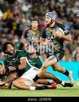 Josh Curran of the Indigenous All Stars runs in to score his sides ...