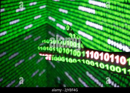 Close up of the data,Binary code，Green binary code on black screen and hand Stock Photo