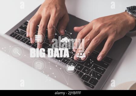 A person utilizing a laptop computer is depicted in a big data idea. Stock Photo