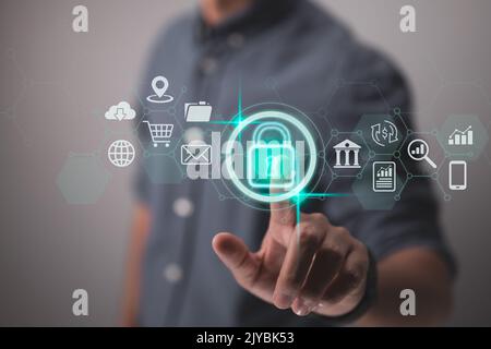 Concepts of cybersecurity and privacy to safeguard data. The lock symbol and internet security technologies. A businessman using virtual screen interf Stock Photo
