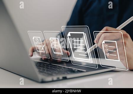 E-signing, electronic signature, document management. A businessman signs an electronic document on a virtual notebook screen. Stock Photo