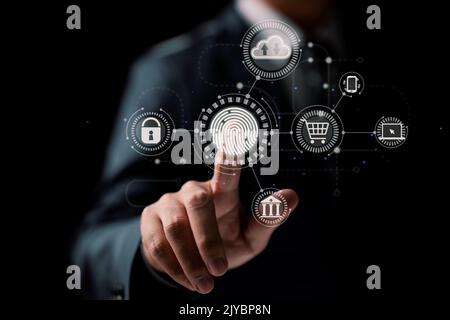 Online transactions, businessman touching fingerprint scan provides security interface payment shopping banking and cloud computing network connection Stock Photo