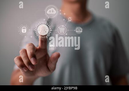 An online businessman scans his fingerprint to login to a cloud computing network. Stock Photo