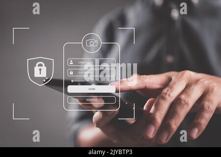 In his account, a businessman with a cellphone is safe. Hacking a Phishing mobile phone with a password to get access to a smartphone, internet securi Stock Photo