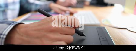 Woman graphic designer graphics tablet at table closeup Stock Photo