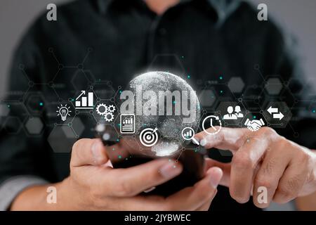 A businessman using a mobile smartphone. Financial and banking, digital link technology, and big data are examples of business global internet connect Stock Photo