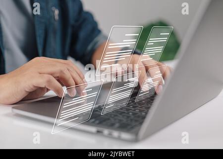 A businessman using a laptop with the idea of a paperless workplace, electronic document icons, electronic document management, and an online document Stock Photo