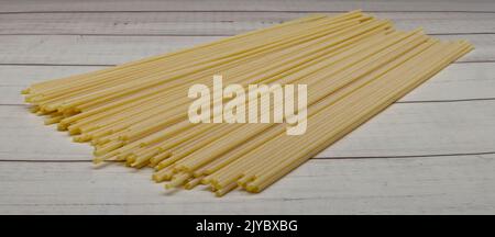 Raw Italian spaghetti isolated on a wooden table Stock Photo