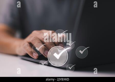 Concept of a check list with a person using a laptop computer Stock Photo