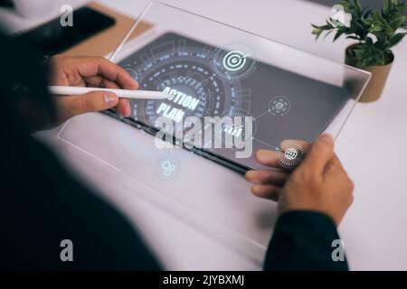 An idea for a business action plan strategy is shown on a tablet screen. The best way to spend your time is to plan it. Stock Photo