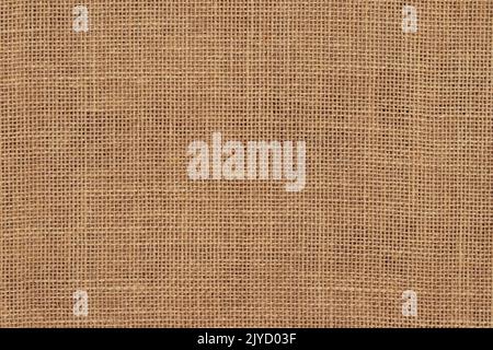 Brown burlap cloth background or sack cloth for packing. Natural linen threads texture. Sackcloth, empty space. Wrapping detail, old grainy cotton bac Stock Photo