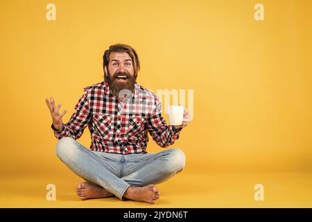 i like this. good morning to you. energetic warm beverage. need some coffee for inspiration. perfect start of the day. surprised bearded man drinking Stock Photo
