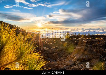 The sun sinks into the clouds on a mountainside in Tenerife Stock Photo